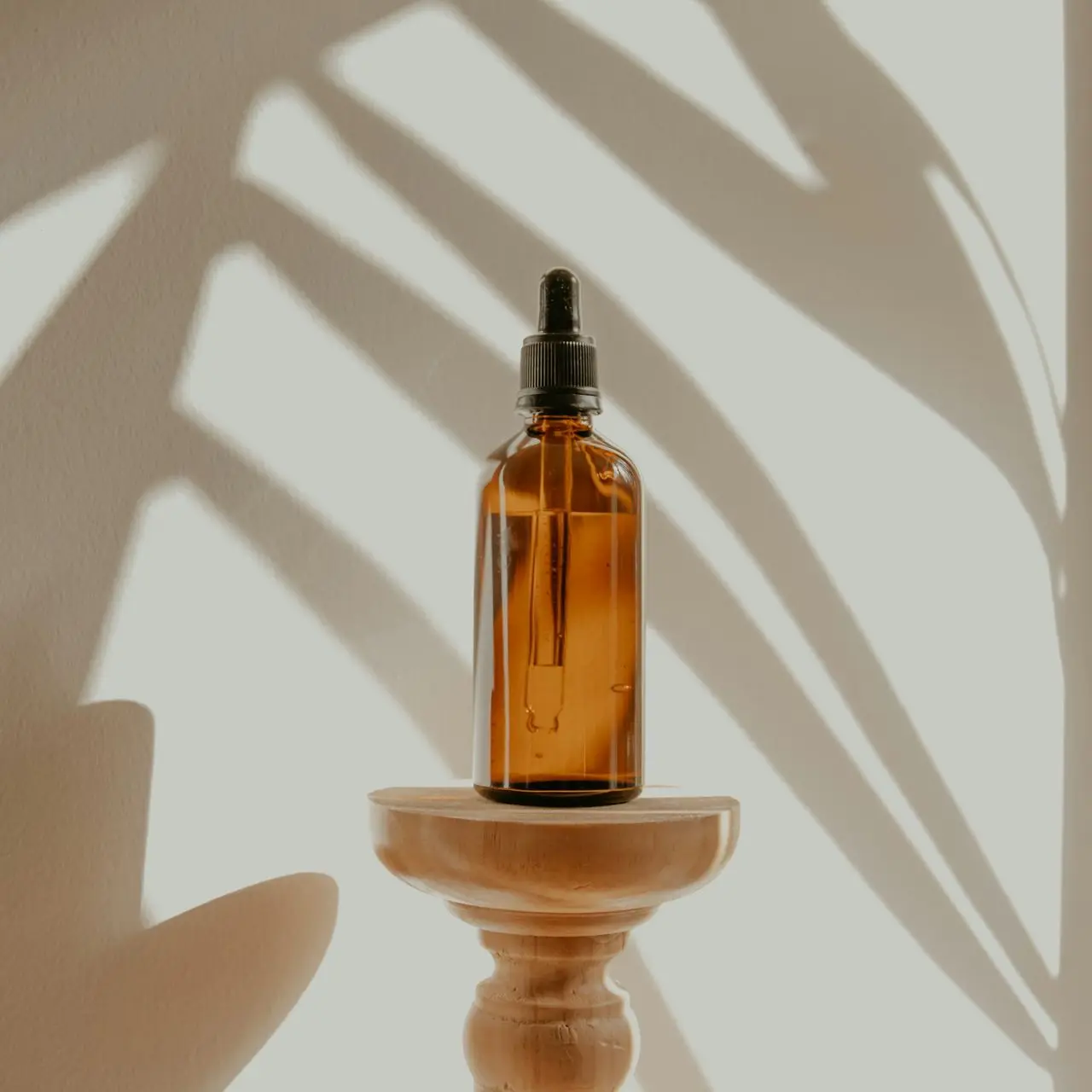clear glass bottle on white wooden round table